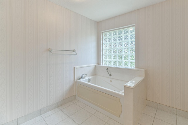 bathroom with a bathing tub and tile patterned flooring