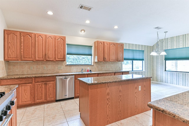 kitchen with a center island, sink, hanging light fixtures, light tile patterned flooring, and stainless steel dishwasher