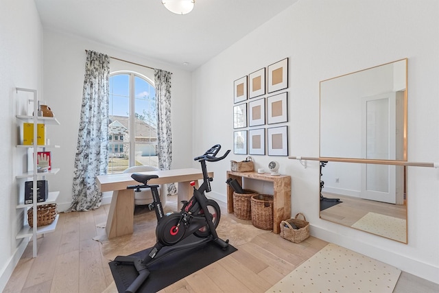 workout room featuring light wood-type flooring