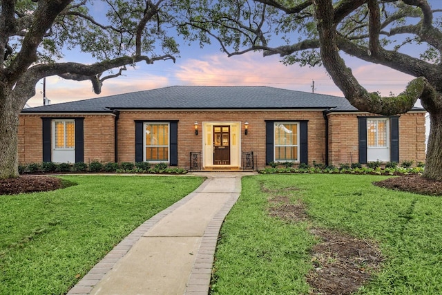 ranch-style house featuring a lawn