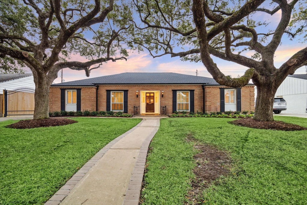 ranch-style house with a yard