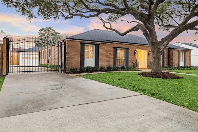 ranch-style home with a yard