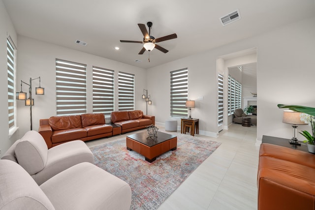 living room featuring ceiling fan and light tile patterned floors