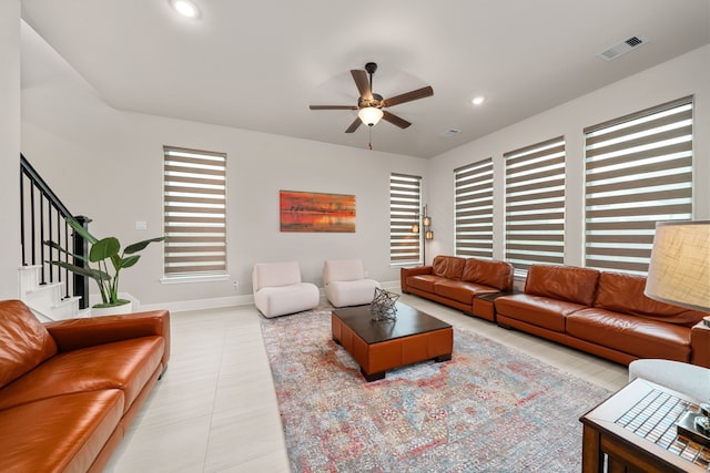 living room featuring ceiling fan and light tile patterned floors