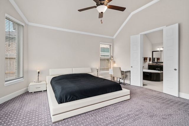 carpeted bedroom featuring ceiling fan, multiple windows, connected bathroom, and lofted ceiling