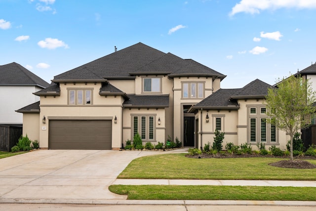 view of front of property featuring a garage and a front lawn