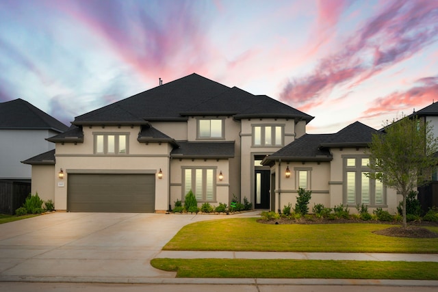 view of front of home featuring a garage and a yard