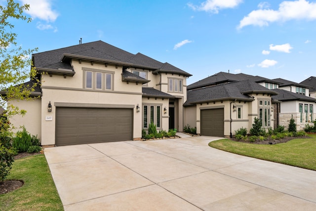 prairie-style house featuring a garage and a front lawn