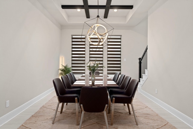 dining space featuring a chandelier, beam ceiling, and hardwood / wood-style floors