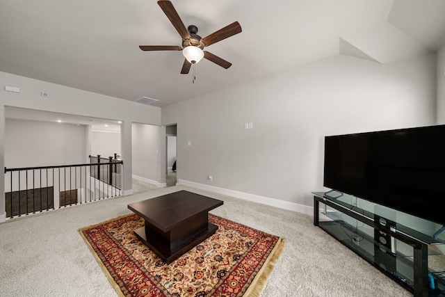 living room featuring ceiling fan, carpet flooring, and lofted ceiling