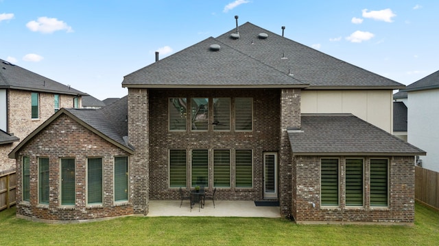 back of property featuring a lawn and a patio