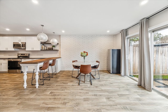 dining room with brick wall