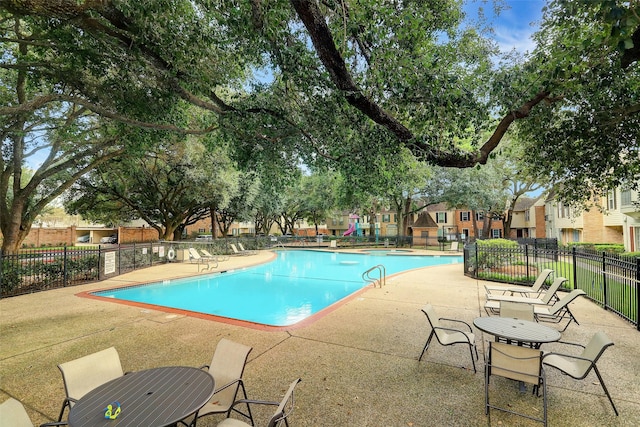 view of swimming pool with a patio