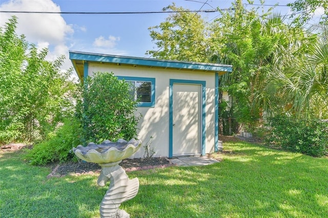 view of outbuilding featuring a lawn