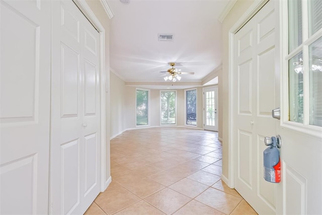 tiled entrance foyer featuring ceiling fan and ornamental molding