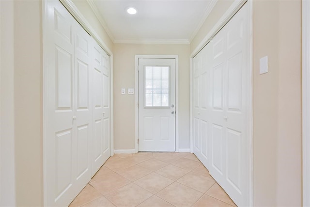 doorway to outside with light tile patterned flooring and crown molding