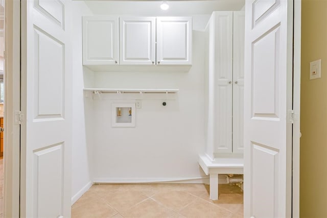 laundry area featuring cabinets, light tile patterned flooring, hookup for a washing machine, and hookup for an electric dryer