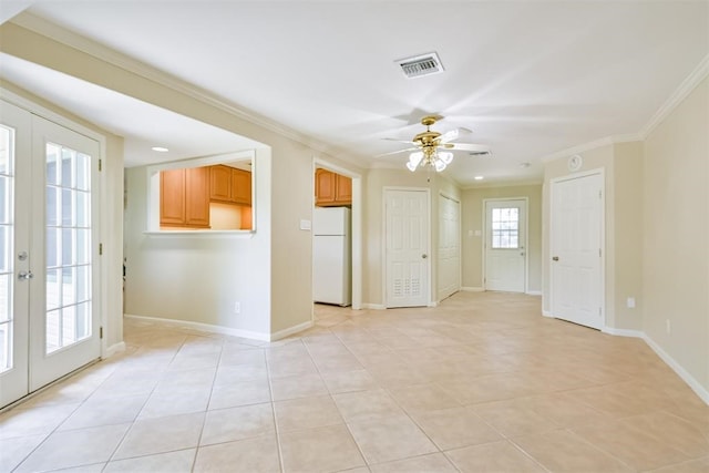 tiled empty room with ceiling fan, ornamental molding, and french doors