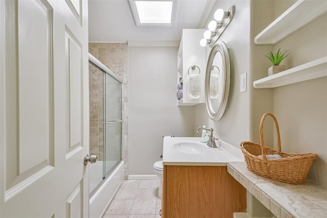 full bathroom featuring toilet, bath / shower combo with glass door, tile patterned floors, crown molding, and a skylight