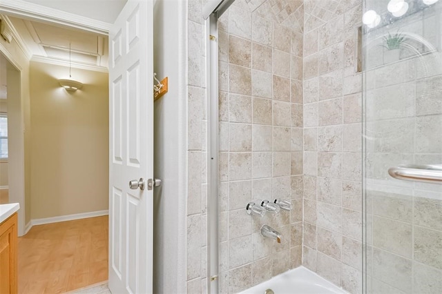 bathroom featuring tiled shower / bath, vanity, crown molding, and hardwood / wood-style floors