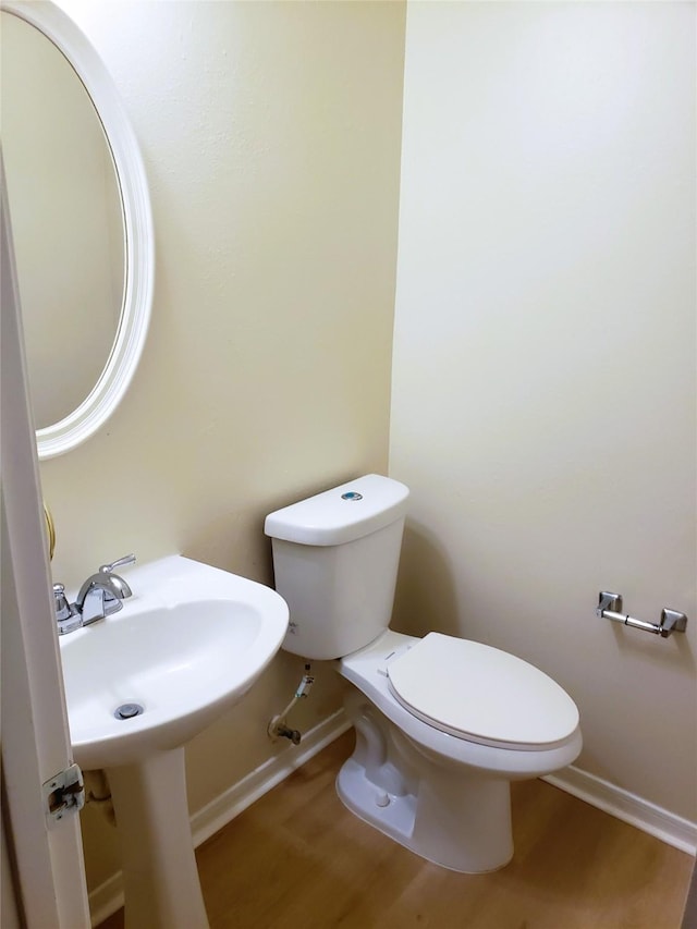 bathroom with wood-type flooring and toilet