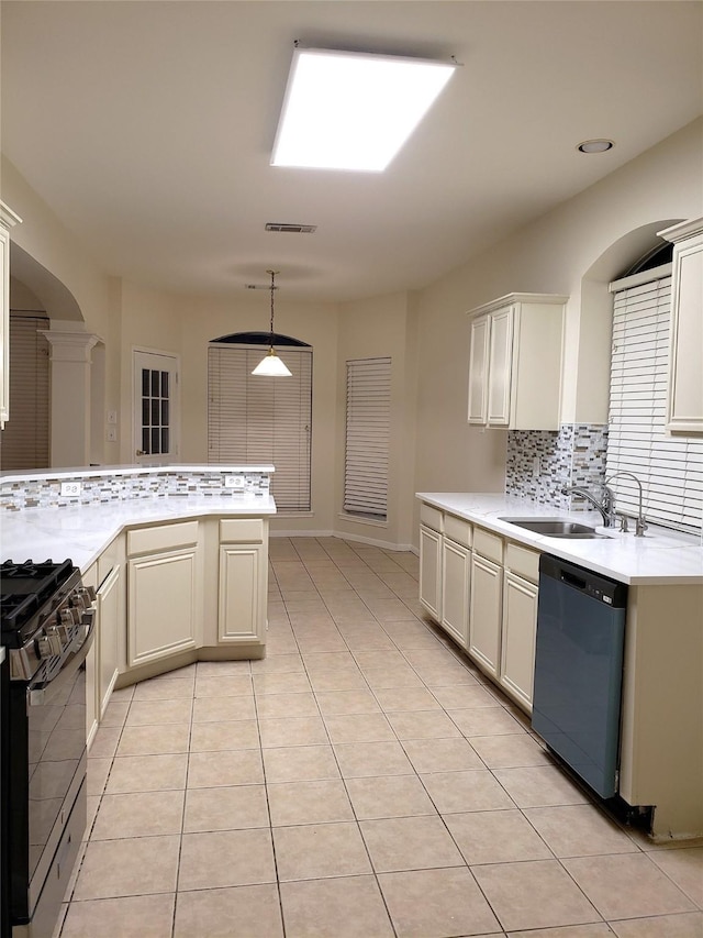 kitchen featuring light tile patterned floors, black dishwasher, gas range, hanging light fixtures, and sink