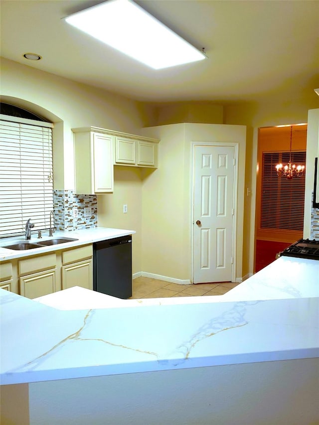 kitchen with black dishwasher, decorative backsplash, decorative light fixtures, a chandelier, and sink