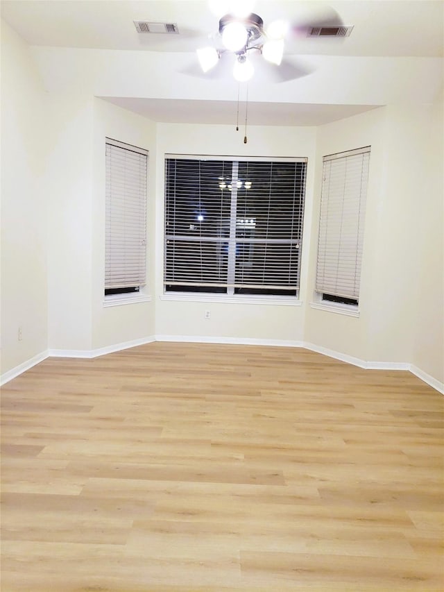 empty room with light hardwood / wood-style floors and ceiling fan