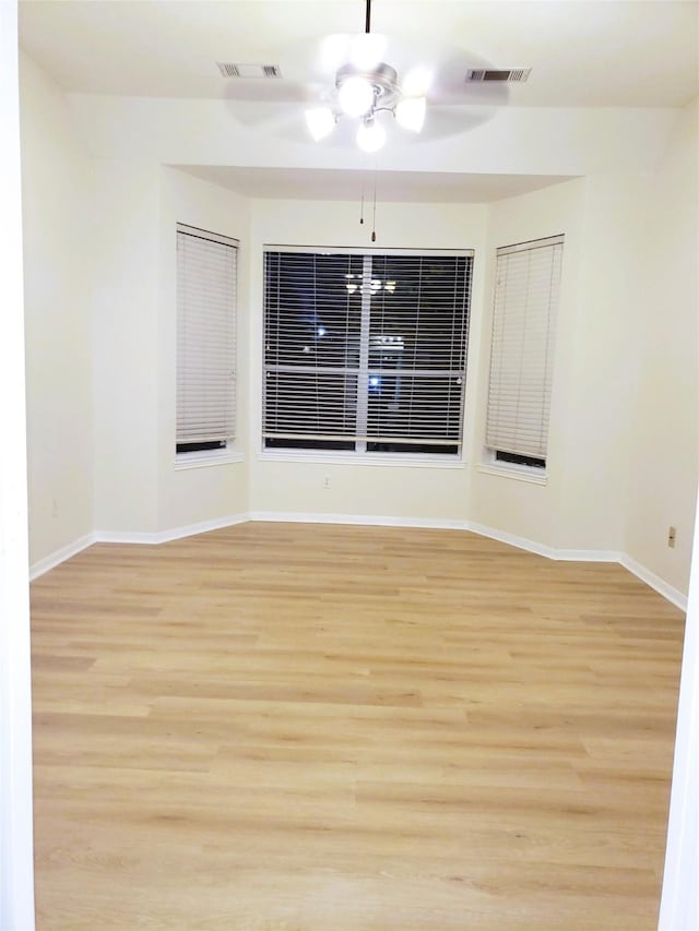 spare room with light hardwood / wood-style floors and ceiling fan