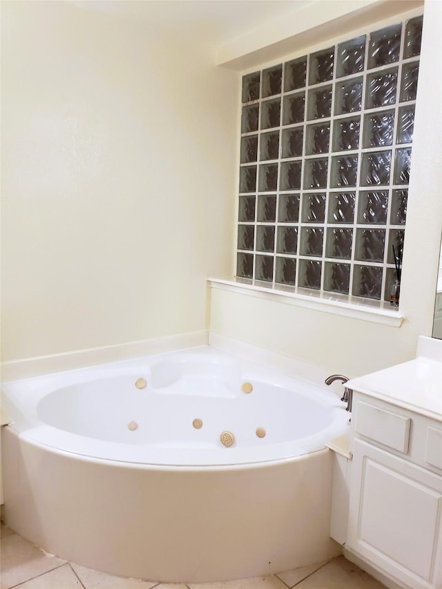 bathroom with vanity, tile patterned flooring, and a tub