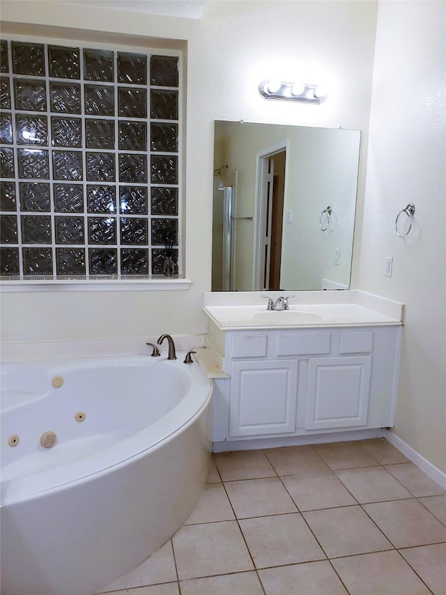 bathroom with vanity, tile patterned floors, and a bath