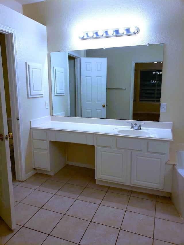 bathroom with vanity, tile patterned floors, and a washtub