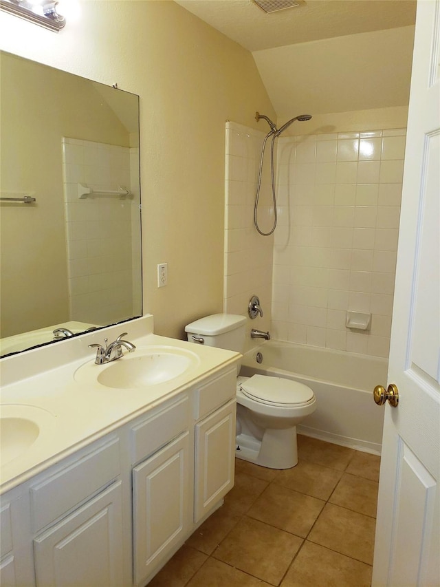 full bathroom with tile patterned floors, vanity, toilet, vaulted ceiling, and shower / bathtub combination