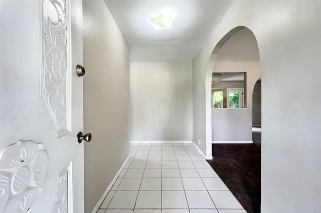 hallway featuring light tile patterned floors