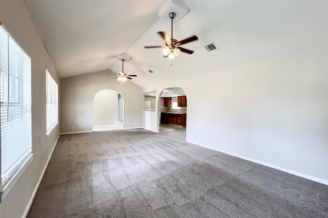 unfurnished living room with vaulted ceiling, ceiling fan, built in features, and carpet floors