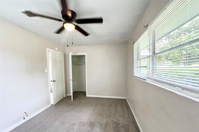 unfurnished bedroom with ceiling fan, carpet, and a closet