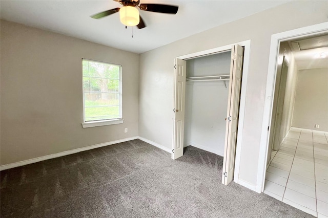 unfurnished bedroom with ceiling fan, a closet, and light carpet