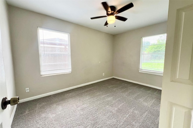 carpeted empty room featuring ceiling fan