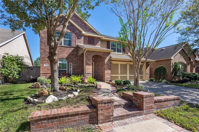 view of front of property featuring a front yard and a garage