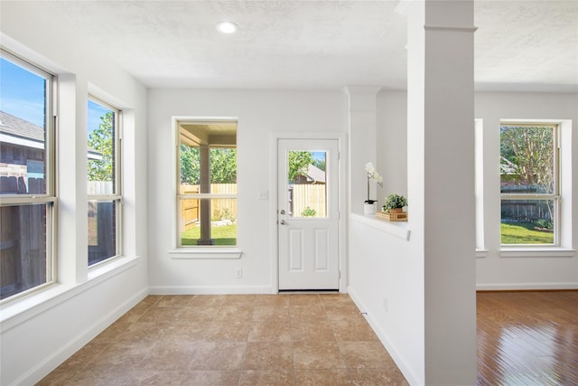 entrance foyer with plenty of natural light and a textured ceiling