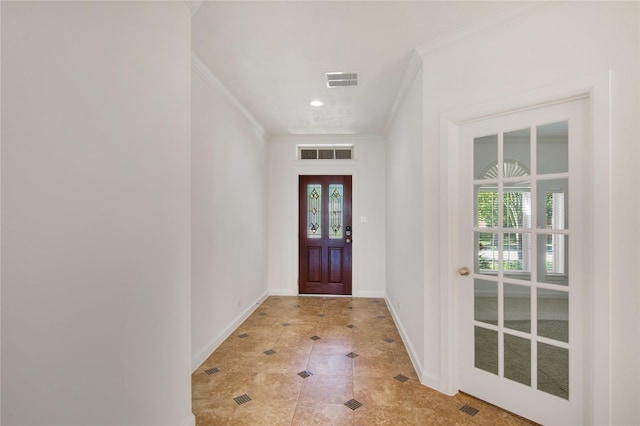 interior space featuring light tile patterned floors and crown molding