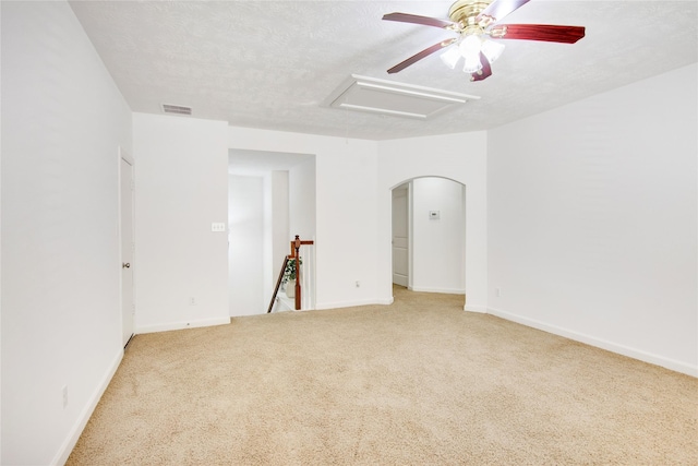 carpeted spare room with ceiling fan and a textured ceiling