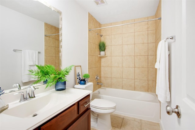 full bathroom featuring toilet, tiled shower / bath combo, tile patterned floors, and vanity