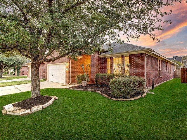 view of front of house featuring a lawn and a garage