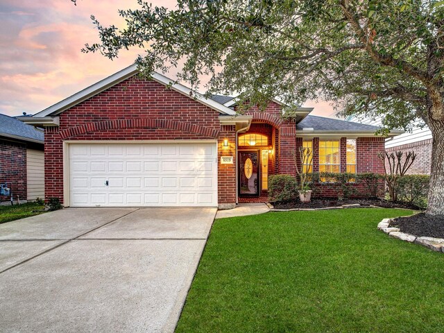 ranch-style house with a lawn and a garage