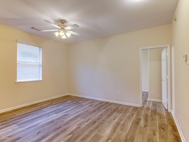 spare room with ceiling fan and light hardwood / wood-style flooring