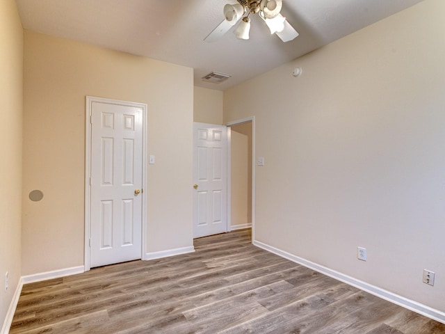 unfurnished bedroom featuring ceiling fan and light hardwood / wood-style floors