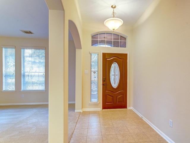 entryway with light tile patterned floors