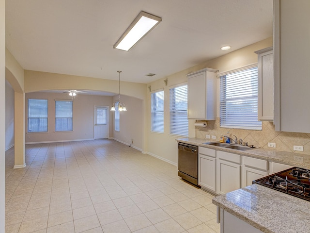 kitchen with dishwasher, sink, white cabinetry, light tile patterned floors, and ceiling fan with notable chandelier