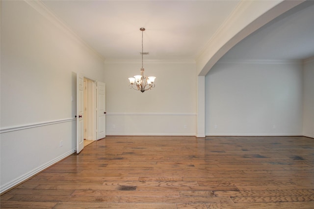 interior space featuring a notable chandelier, ornamental molding, and hardwood / wood-style flooring